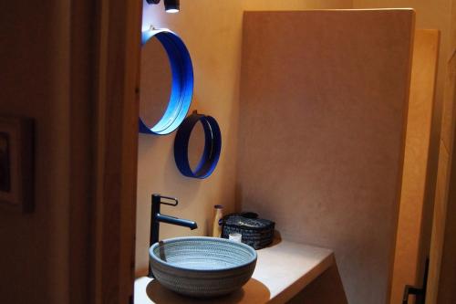 a bathroom with a bowl sink and mirrors on the wall at Villa Labri de la Plage 350 m from Beach & Center in Sidi Kaouki