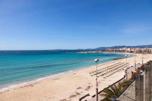 a view of a beach with chairs and the ocean at Hotel Eden Palma Playa Adults Only in Can Pastilla
