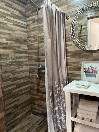 a bathroom with a shower with a shower curtain at Hostería Las Rosas Trevelin in Trevelín