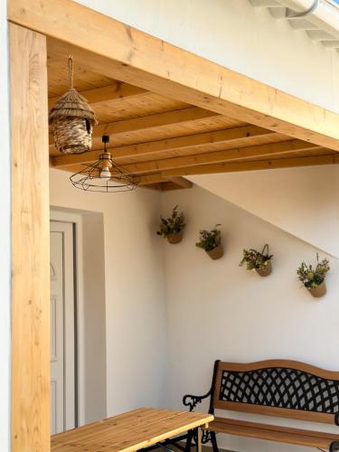 a dining room with a wooden table and a bench at Casa Rústica em Loulé - Karmea's Houses in Loulé