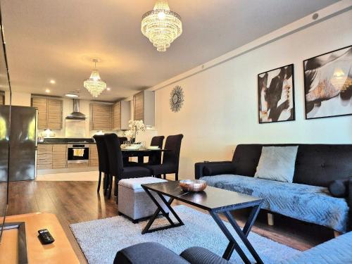 a living room with a couch and a table at Explore London: 2 Bedroom House in Wood Green in London