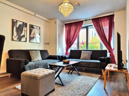 a living room with two couches and a table at Explore London: 2 Bedroom House in Wood Green in London