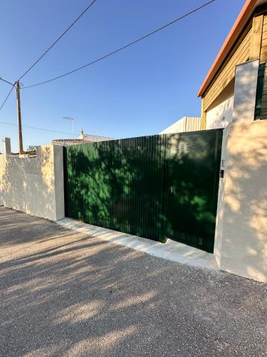 a large black gate on the side of a building at Casa Rústica em Loulé - Karmea's Houses in Loulé