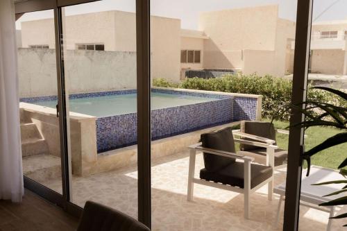 a view of a swimming pool from a house at House of Flores Villa Bavaro in Punta Cana