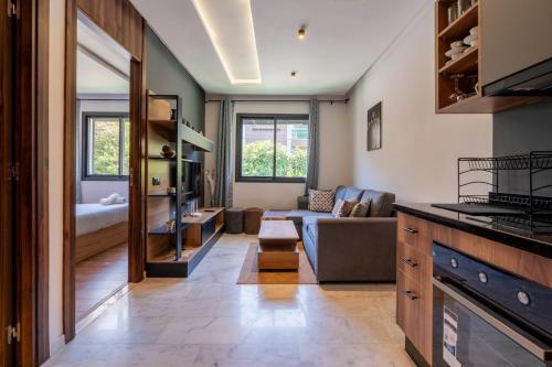 a living room with a couch and a table at Résidence Cerezo in Maarif
