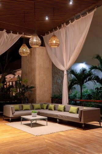 a living room with a couch and a table at Hotel Mundo Maya Tulum in Tulum