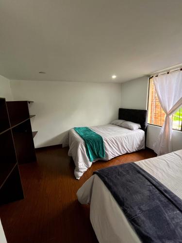 Una cama o camas en una habitación de Quinta los Parques
