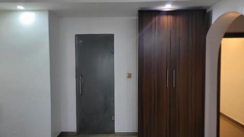 a room with a wooden closet and a door at Mareot Hotel & Spa in Lagos