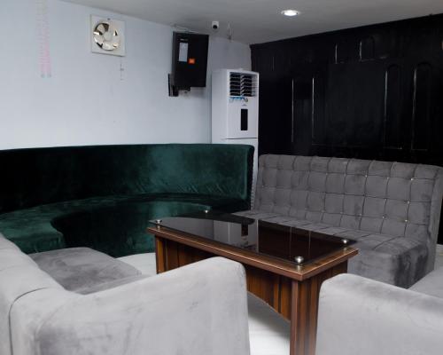 a living room with two couches and a coffee table at Mareot Hotel & Spa in Lagos