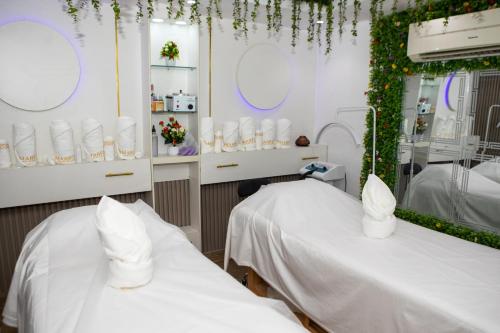 a hospital room with two beds and a mirror at Mareot Hotel & Spa in Lagos