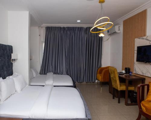 a hotel room with a bed and a dining room at Mareot Hotel & Spa in Lagos