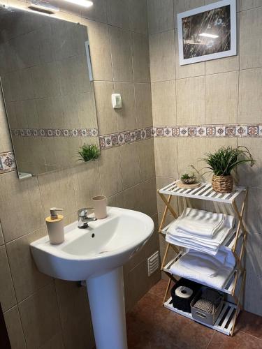 a bathroom with a white sink and a mirror at A Casa da Cilarca in Portel