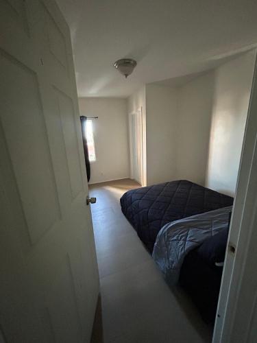 a bedroom with a bed and an open door at Hollywood Home in Los Angeles