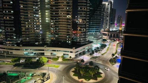 a view of a city at night with buildings at Magnificent Partition Room in Barsha Heights Tecom in Dubai