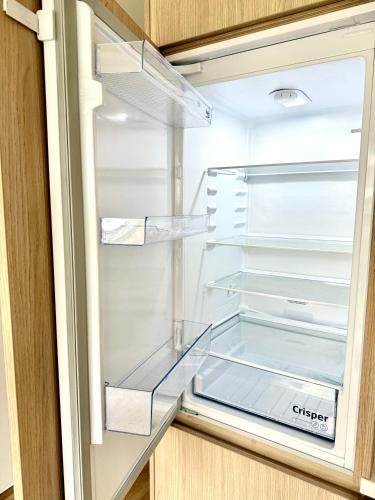 an empty refrigerator with its door open at Calm and Modern Flat with Free Parking 10mins on bus to City Centre 1min walk to Bus stop in Košice