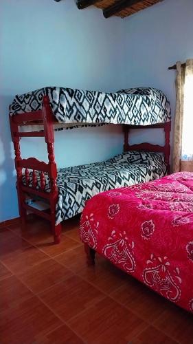 a living room with a couch and a bed at Hospedaje Familiar Tilcara in Tilcara