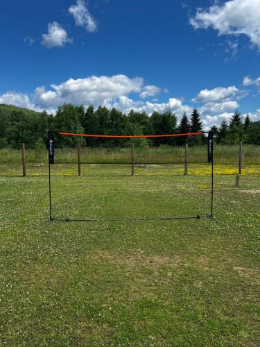 a net in the middle of a field at PETE HOUSE in Ustrzyki Dolne