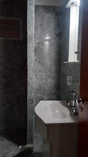 a bathroom with a sink and a glass shower at Alojamiento Lindo Amanecer in Mercedes