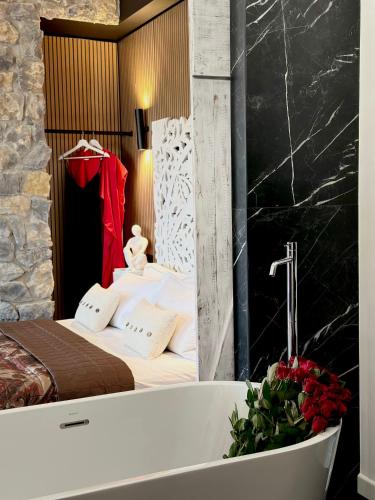a bedroom with a bed and a bath tub at FORTUNA ORO Luxury Stay in Verona
