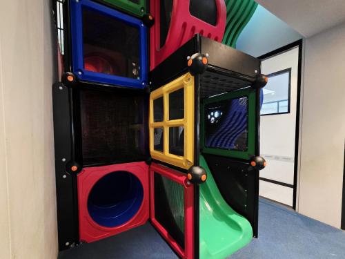 a childrens play room with a slide at Panania Hotel Sydney in Panania