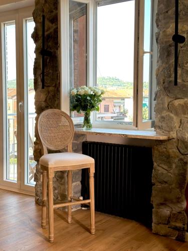 a chair sitting in front of a window at FORTUNA ORO Luxury Stay in Verona
