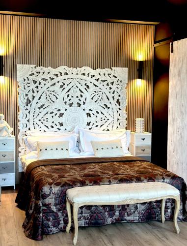 a bedroom with a large bed with a white headboard at FORTUNA ORO Luxury Stay in Verona