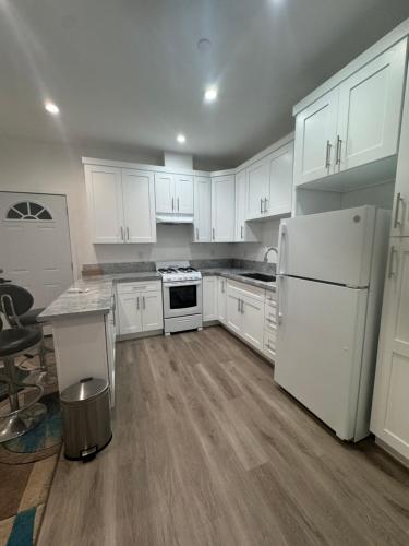 a kitchen with white cabinets and a white refrigerator at Stunning Guest House in West Hills California in Hughes-Canoga Park Heliport