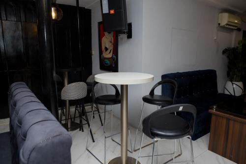 a room with a couch and a table and chairs at Mareot Hotel & Spa in Lagos