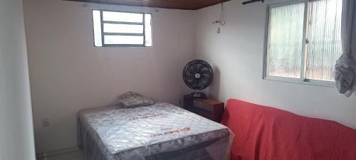 a room with a bed and a clock on the wall at Casatelégrafo in Belém