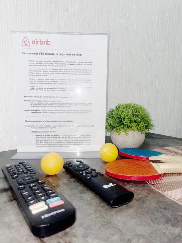 a remote control sitting on a counter next to a piece of paper at Ubicado en coto privado a 5km de Nuevo Vallarta in Mezcales