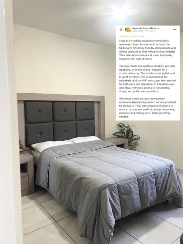 a bedroom with a bed with a poster on the wall at Ubicado en coto privado a 5km de Nuevo Vallarta in Mezcales