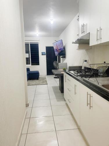 a kitchen with white cabinets and a counter top at Ubicado en coto privado a 5km de Nuevo Vallarta in Mezcales
