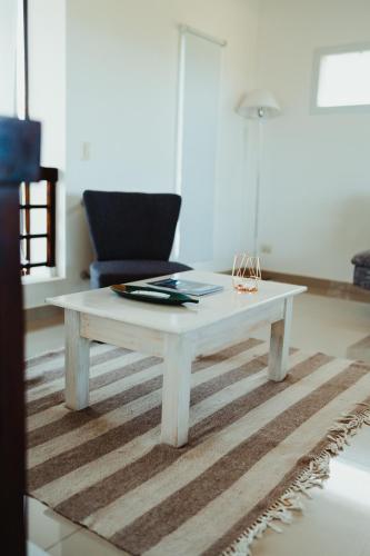 a white coffee table in a living room with a couch at Casa Pampa Cabañas in Chapadmalal