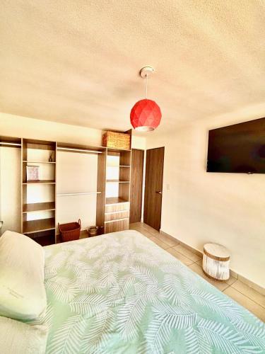 a bedroom with a large bed and a flat screen tv at Departamento Boutique con más Amenidades que Ningún otro en la Zona in Acapulco