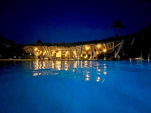 a building at night with lights on the water at Mayan Palace, Grand Mayan, Luxury Beachfront 2BR Condo, Nuevo Vallarta in Nuevo Vallarta 