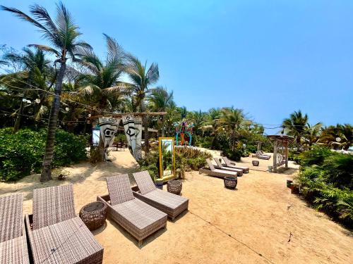 a group of lounge chairs and palm trees on a beach at Mayan Palace, Grand Mayan, Luxury Beachfront 2BR Condo, Nuevo Vallarta in Nuevo Vallarta 