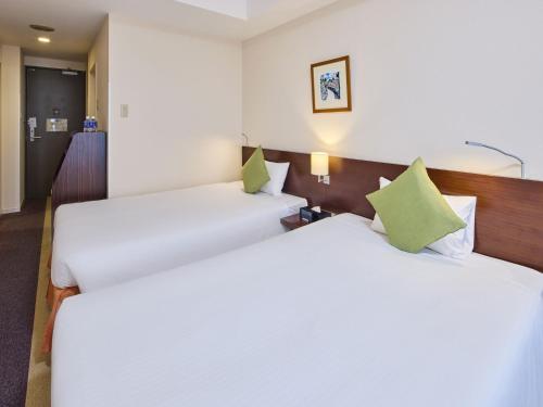 Ένα ή περισσότερα κρεβάτια σε δωμάτιο στο Hotel Yugaf Inn Okinawa