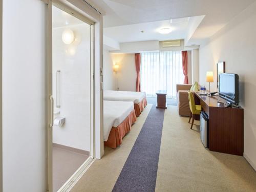 Ένα ή περισσότερα κρεβάτια σε δωμάτιο στο Hotel Yugaf Inn Okinawa
