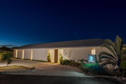 a white building with a sign in front of it at St Maire Yoron Sheera Villa in Yoron
