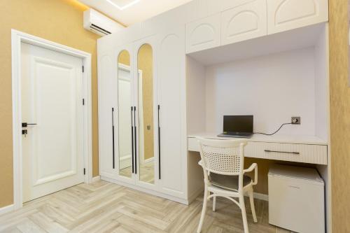 a room with a desk with a computer on it at Caspian Colorful Villas in Lankaran