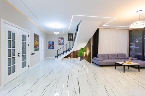 a living room with a couch and a table at Caspian Colorful Villas in Lankaran