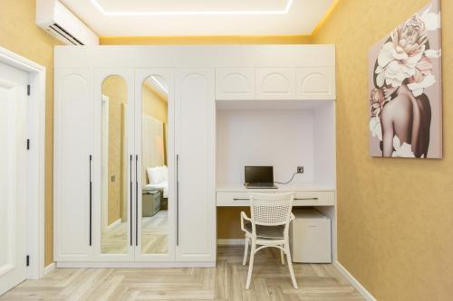 a room with a desk with a computer and a chair at Caspian Colorful Villas in Lankaran