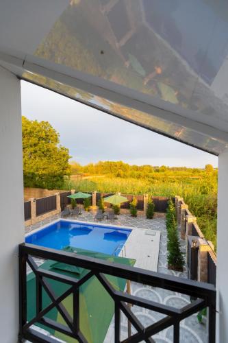 a view from the balcony of a house with a swimming pool at Caspian Colorful Villas in Lankaran