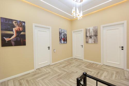 a room with two doors and paintings on the walls at Caspian Colorful Villas in Lankaran