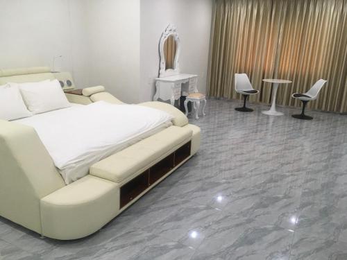 a hospital room with a bed and two chairs at DONG PHUONG HOTEL in Bao Loc