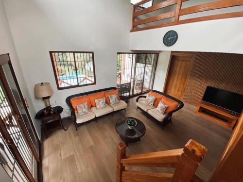 an overhead view of a living room with couches and a television at Villa Emilia - San Cristóbal, Dominican Republic in San Cristóbal