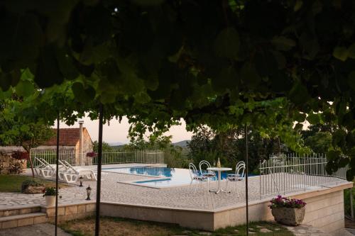 a swimming pool in a yard with a fence at Sabljić Estate in Široki Brijeg