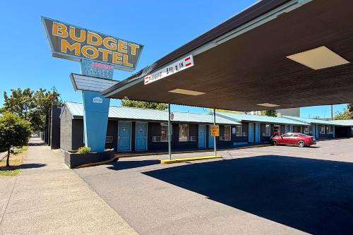 a budget motel with a car parked in a parking lot at Budget Motel in Portland
