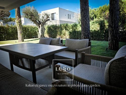 a patio with a table and chairs in a yard at Lusso Villa - San Pietro Melia in Draçi