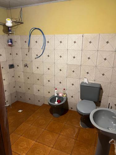 a bathroom with a toilet and a sink at Casa familiar in Encarnación